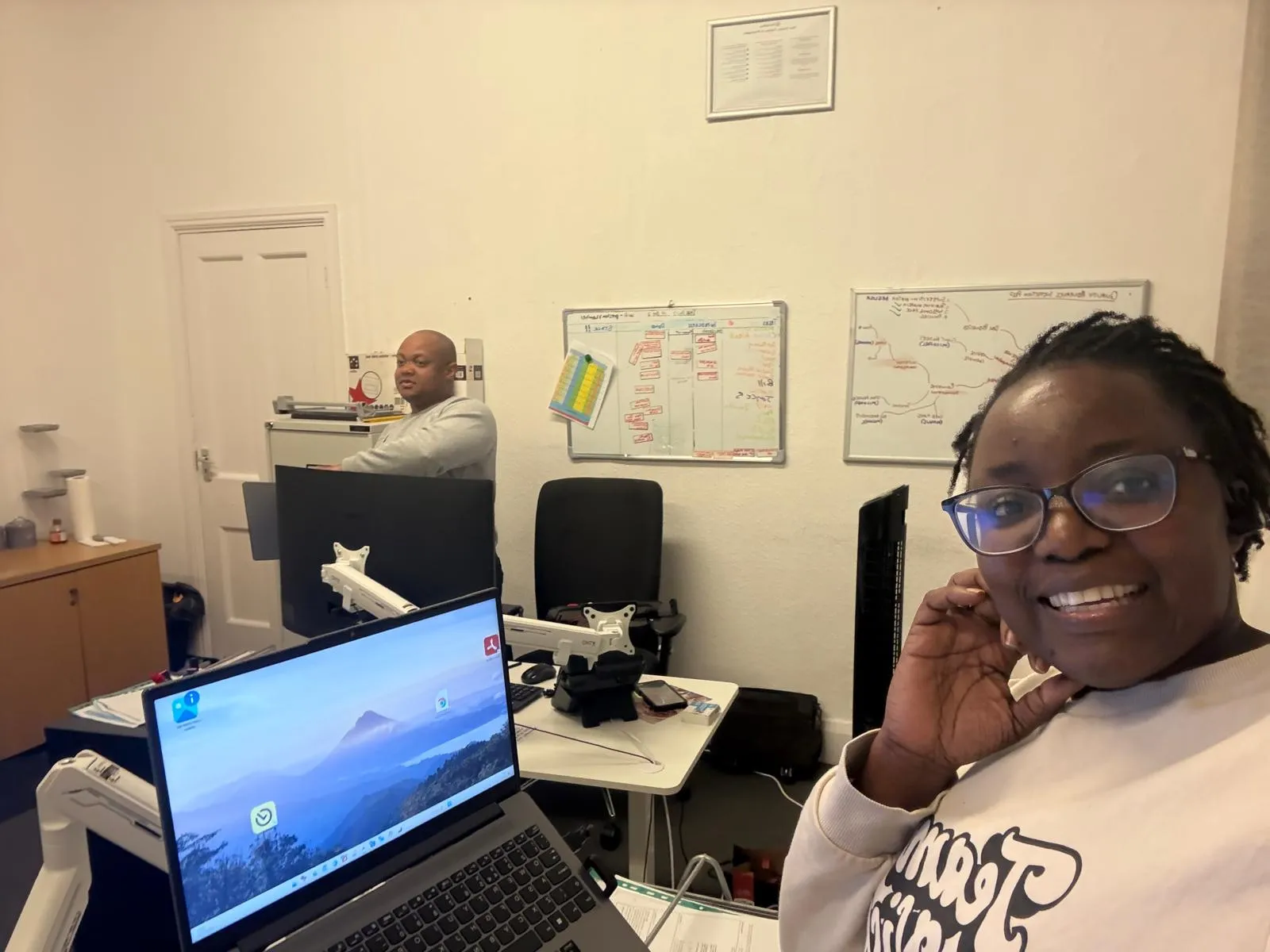 TKS Staffing care coordinator on a headset taking a call at his desk in the Derby office