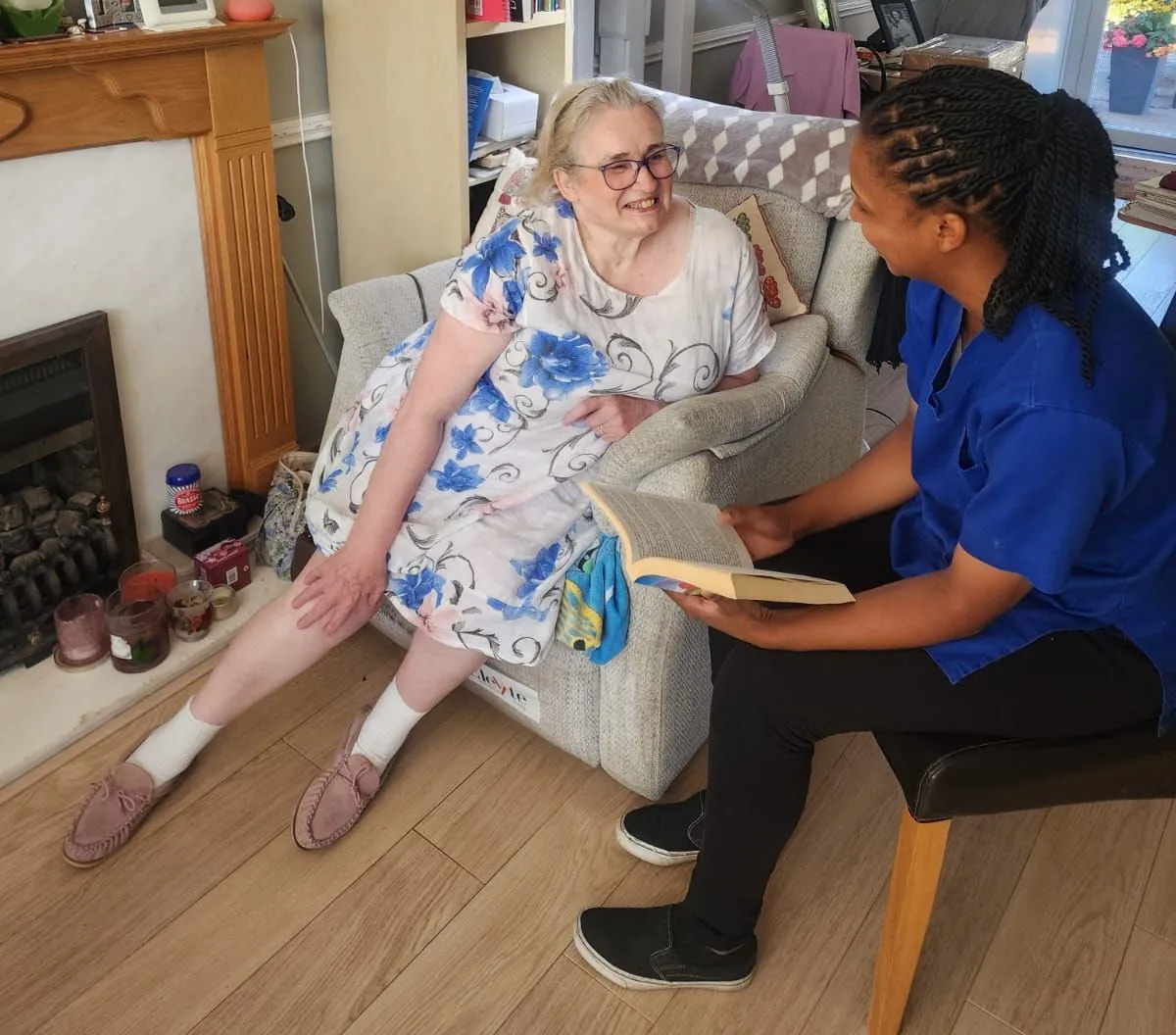 TKS Staffing companionship carer laughing over a game of dominoes with a client in Derby