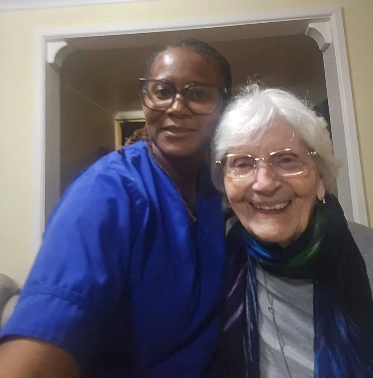 Dementia trained TKS Staffing carer sitting at eye level talking with an elderly client at home in Derbyshire