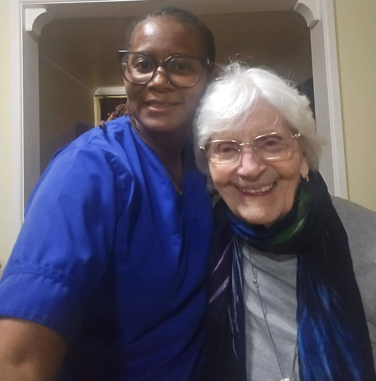 A TKS Staffing carer sharing a quiet moment with a lady she supports at home