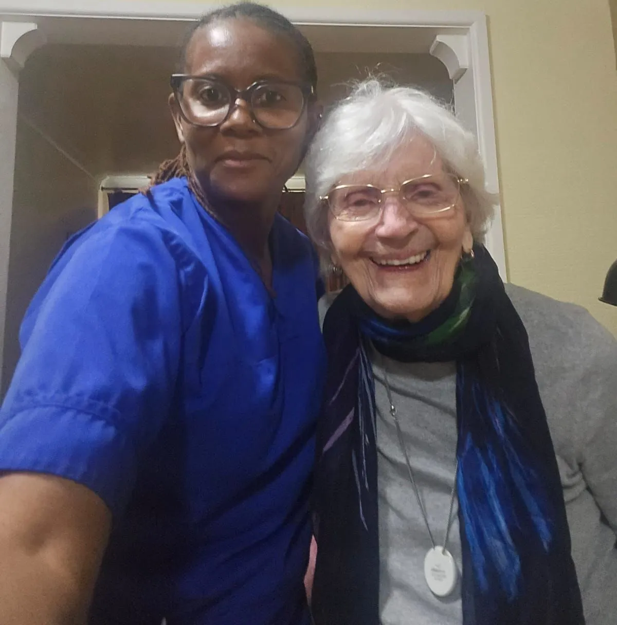 A TKS Staffing carer sharing a quiet moment with a lady she supports at home